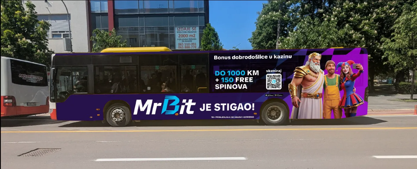 Bus wrapped in MrBit branding on a city street